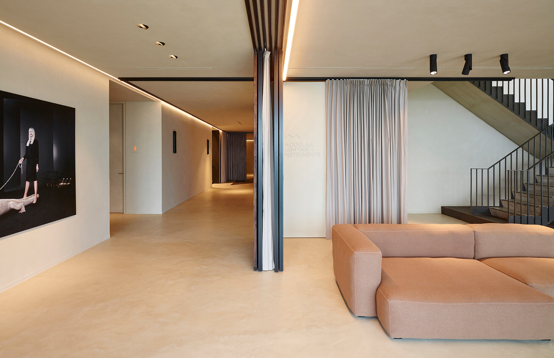 Wooden room dividers and floor-length drapes are used to create spaces in which employees can enjoy their privacy.