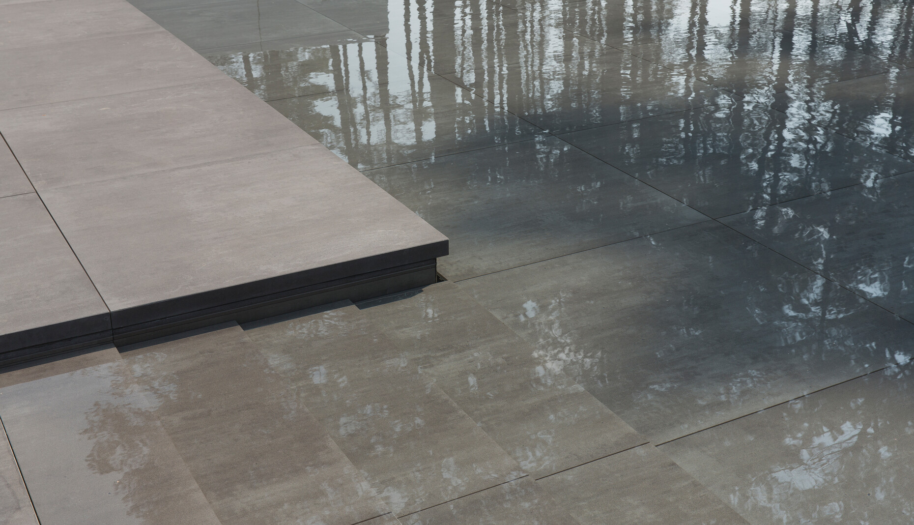 One section of the patio floor can be lowered smoothly to transform into a swimming pool complete with elegant gentle steps.