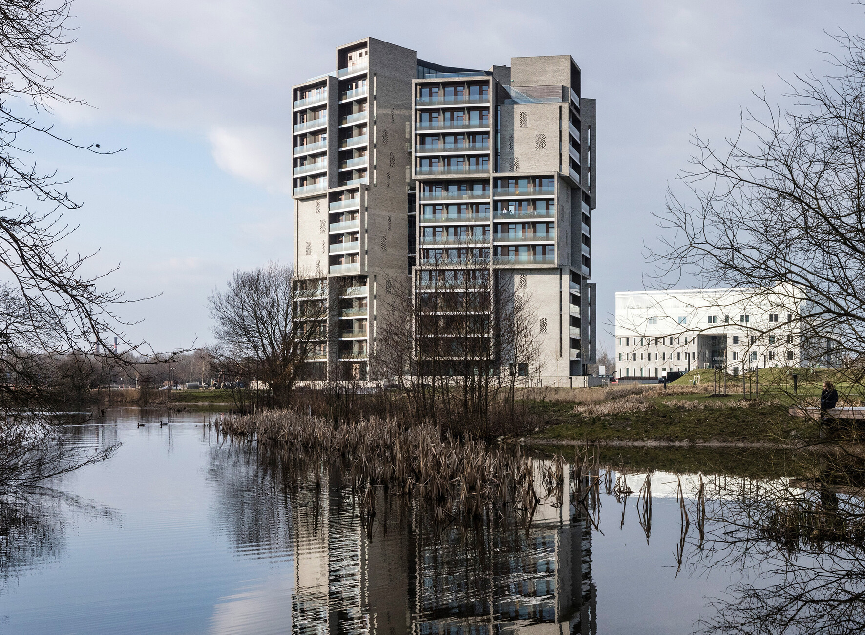 The 15 stories of the tower-like “Campus Kollegiet” in Odense of Denmark's Funen island are rendered less massive by staggering the volumes.