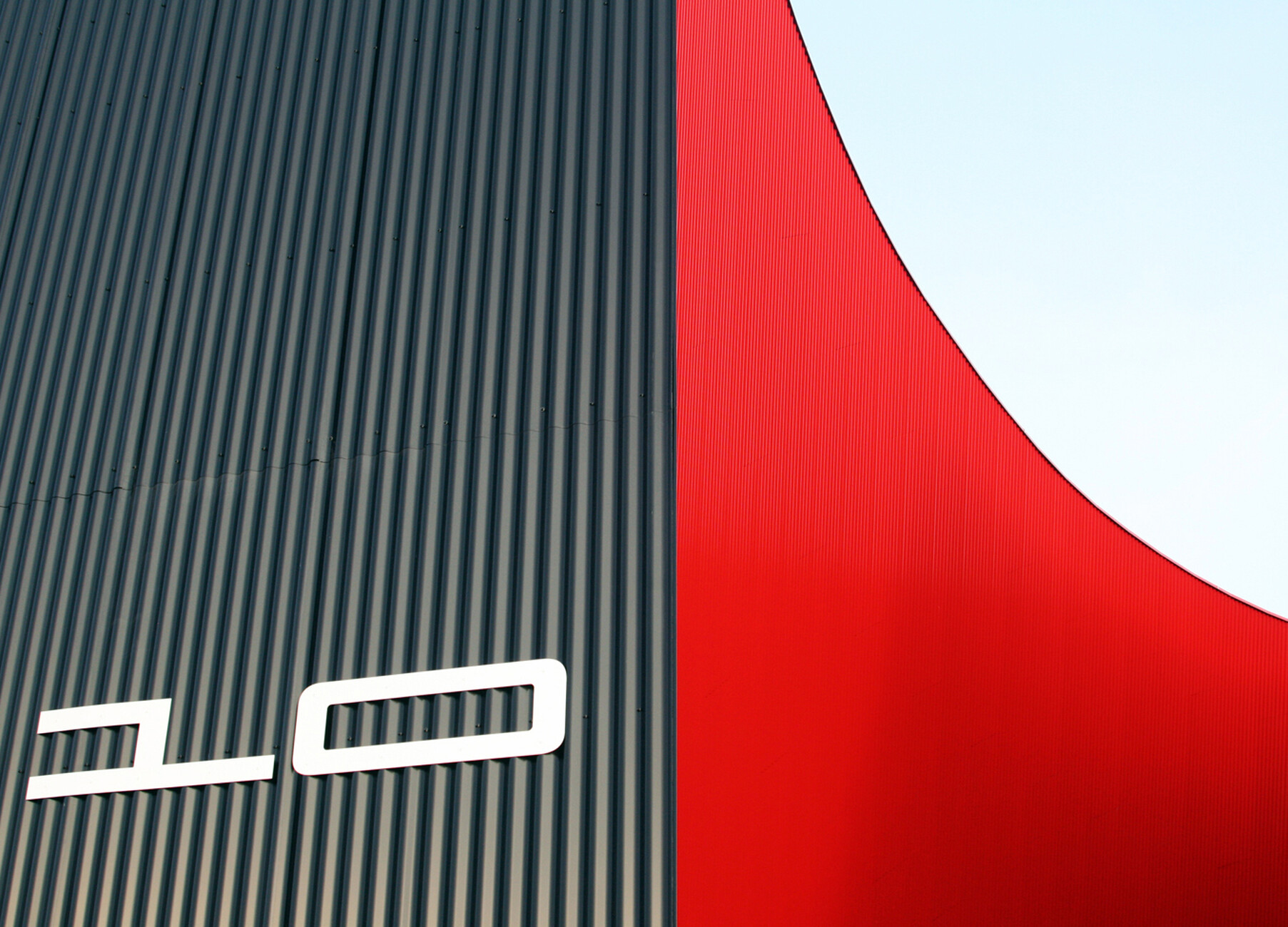 The cut ellipses create tension in the monolithic structure.